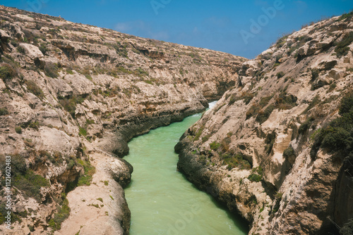 Beautiful view of Wied il-Ghasri cove on the north coast of Gozo Island on a sunny day, Malta