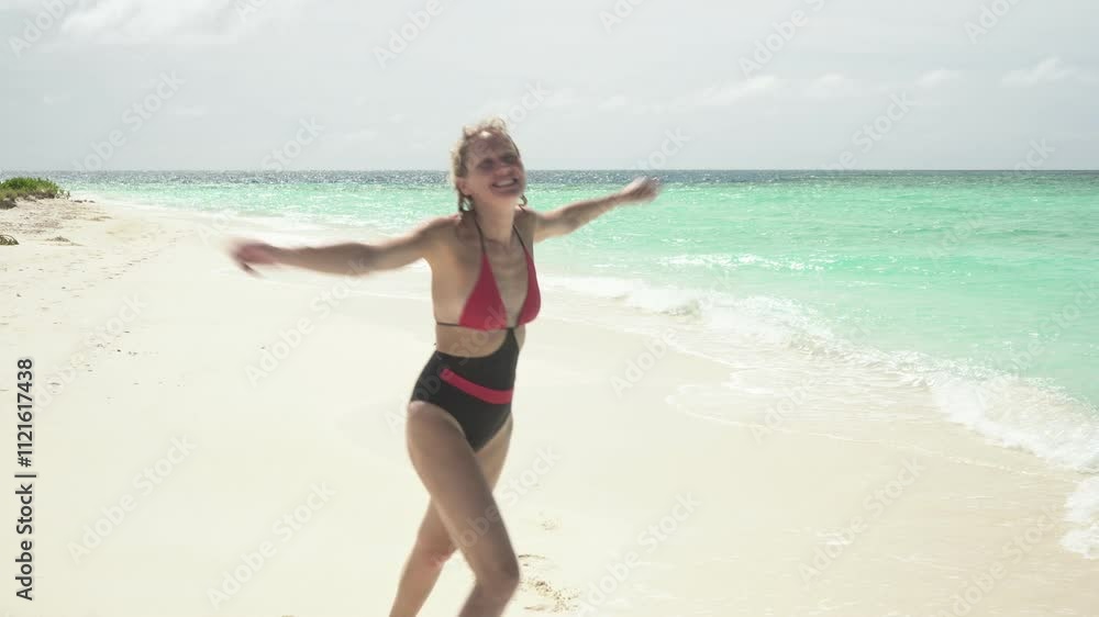 Young slim woman runs along sandy beach on sea, Maldives Young slim woman runs along sandy beach on sea, Maldives
