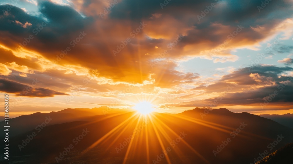 Dramatic sunrise with golden rays breaking through clouds over mountains Dramatic sunrise with golden rays breaking through clouds over mountains