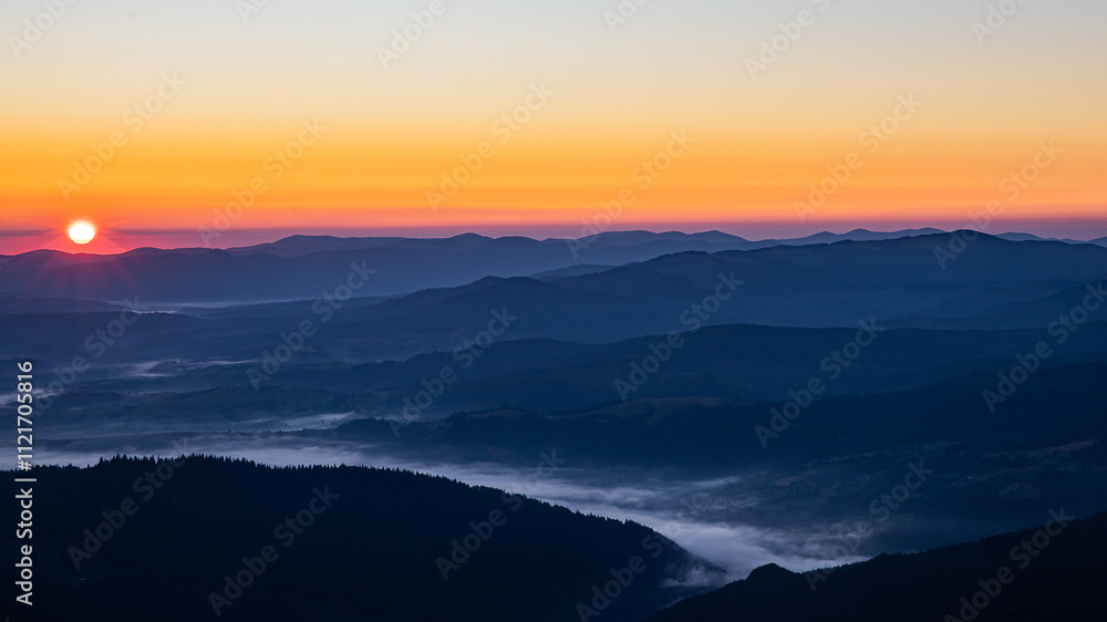 the red sun rises over the mountains, a thick fog still lies in the dark lowlands the red sun rises over the mountains, a thick fog still lies in the dark lowlands