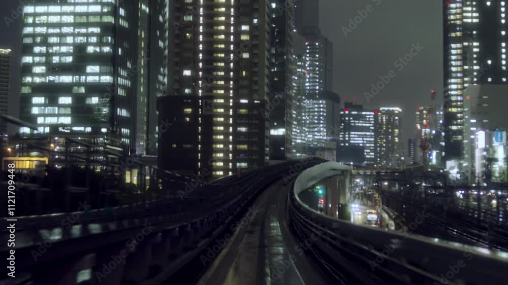 POV View From Train Moving Through Tokyo At Night Showing Buildings POV View From Train Moving Through Tokyo At Night Showing Buildings