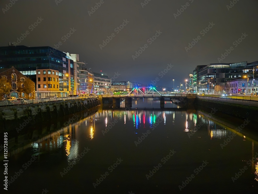 Fototapeta premium Cityscape at Dusk with Water, Sky, and Tower Block Reflections