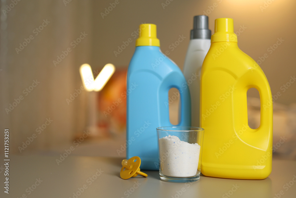 Bright and Colorful Laundry Detergent Bottles Filled with Powder and a Pacifier for Babies Bright and Colorful Laundry Detergent Bottles Filled with Powder and a Pacifier for Babies
