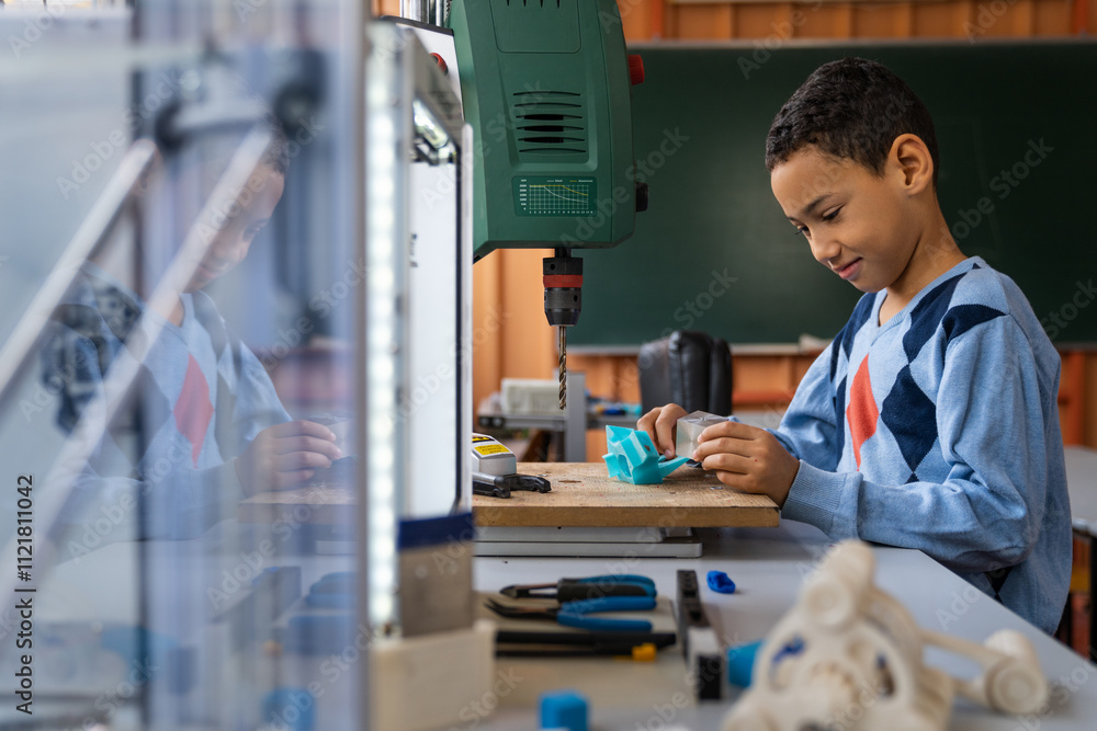 A boy with diverse ethnicity focuses on crafting a project in a well-equipped STEM classroom, surrounded by educational tools. A boy with diverse ethnicity focuses on crafting a project in a well-equipped STEM classroom, surrounded by educational tools.