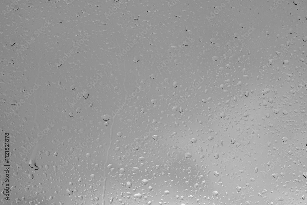 Rain drops on a window indicating gray and rainy day Rain drops on a window indicating gray and rainy day