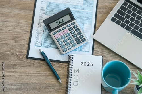 Top view of tax return preparation and financial management concept. calculates taxes using calculator and laptop. finance, Income tax, tax documents photo