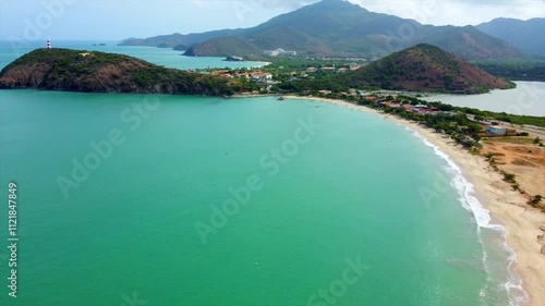 Panorama of Venezuela beach, lighthouse, pier and beautiful sandy beach at sunrise