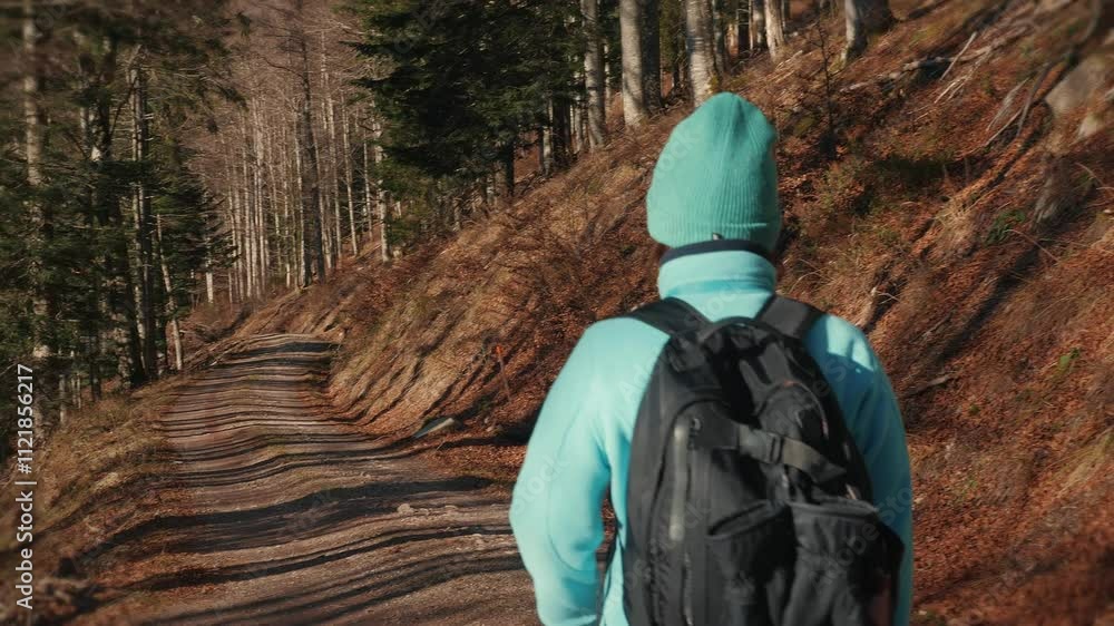 Young female walking in autumn forest, exploring nature and breathing fresh air Young female walking in autumn forest, exploring nature and breathing fresh air