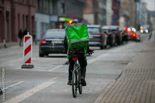 Wallpaper Mural Food courier delivery backpack in green color. Food delivery man on a bike driving on bike lane Torontodigital.ca