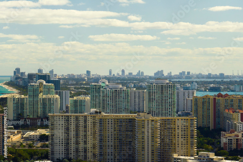 Aerial view of Sunny Isles Beach city with luxurious highrise hotels and condos on Atlantic ocean shore. American tourism infrastructure in southern Florida photo