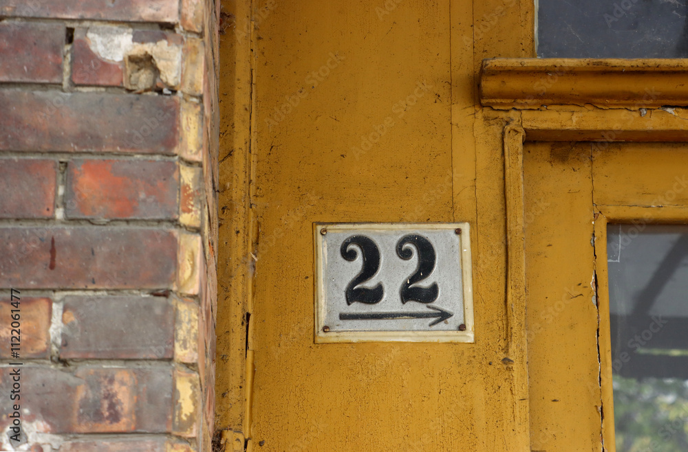 Fototapeta premium Number 22 on old yellow door