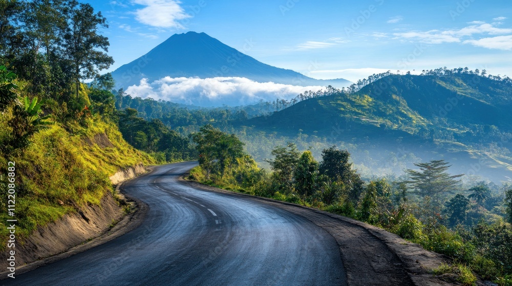 Obraz premium An asphalt road that winds through Indonesian lush mountainous regions, with majestic volcanoes looming in the distance, background wallpaper AI generated image