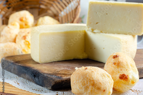 Cheese and cheese bread, a beautiful breakfast table with Brazilian delicacies and accessories on rustic wood, selective focus. photo