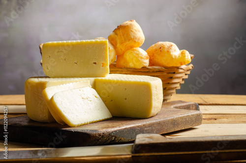 Cheese and cheese bread, a beautiful breakfast table with Brazilian delicacies and accessories on rustic wood, selective focus. photo