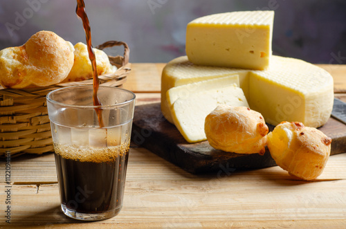 Cheese and cheese bread, a beautiful breakfast table with Brazilian delicacies and accessories on rustic wood, selective focus. photo