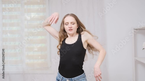 Young woman dancing gracefully in various poses within a bright, airy room filled with natural light and positive energy