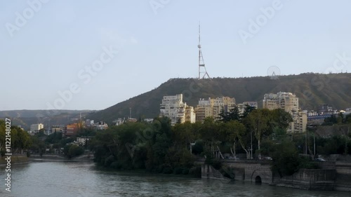 Peaceful view of the Kura River with Mtatsminda Hill in the background