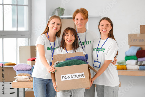 Young volunteers with donat...