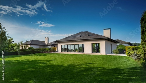 outside view of elegant suburban house with big window green lawn