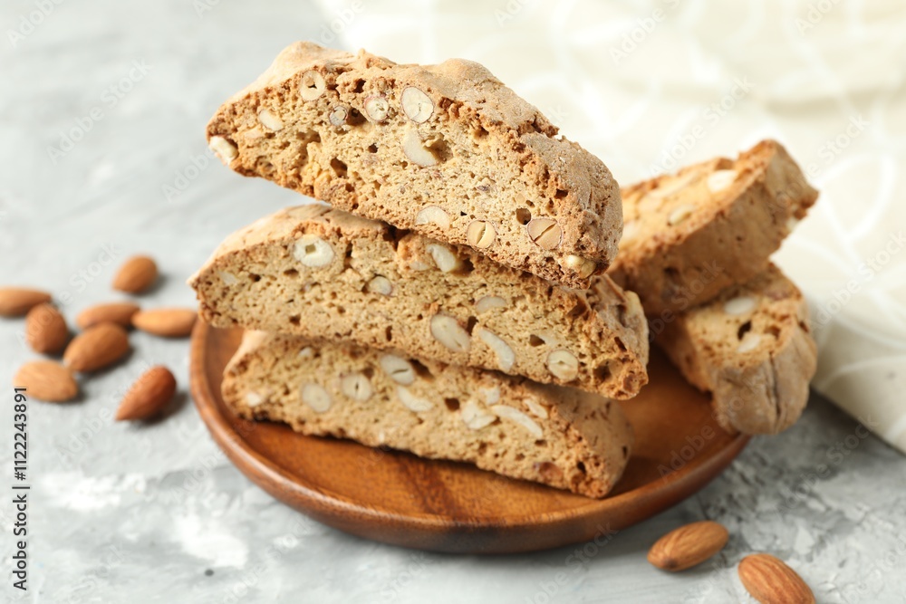 Fototapeta premium Traditional Italian almond biscuits (Cantucci) on grey textured table, closeup
