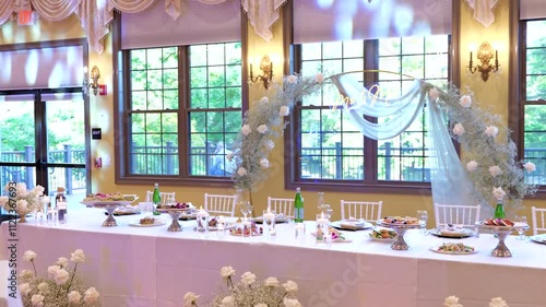 Wedding jewelry. Wedding table with plates, chairs, napkins, decorative fresh and dried flowers, candles and light bulbs.