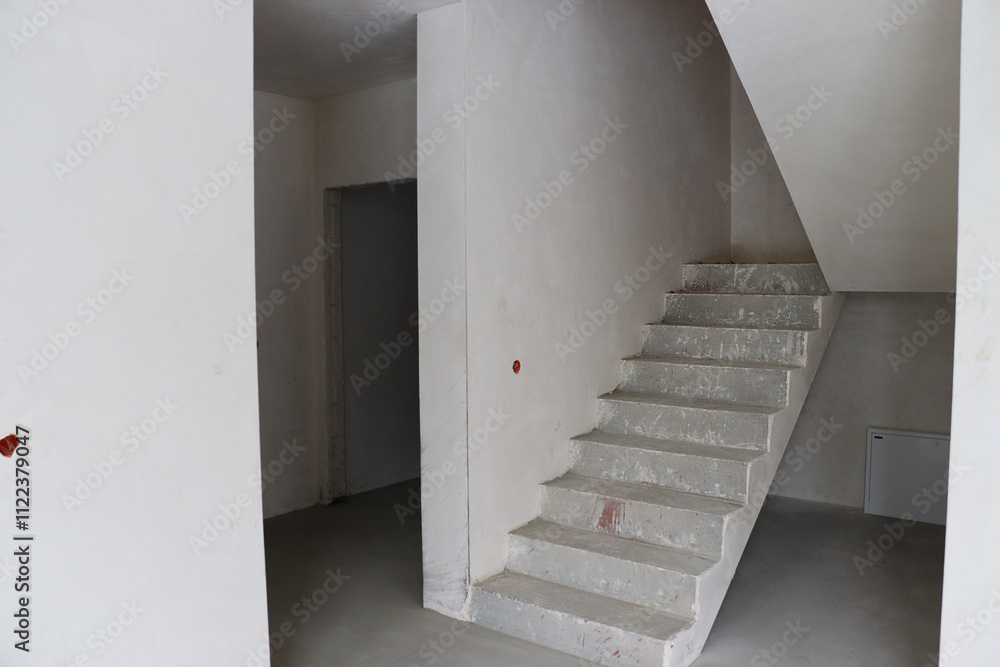 Fototapeta premium monolithic staircase, house before renovation, empty walls, construction 