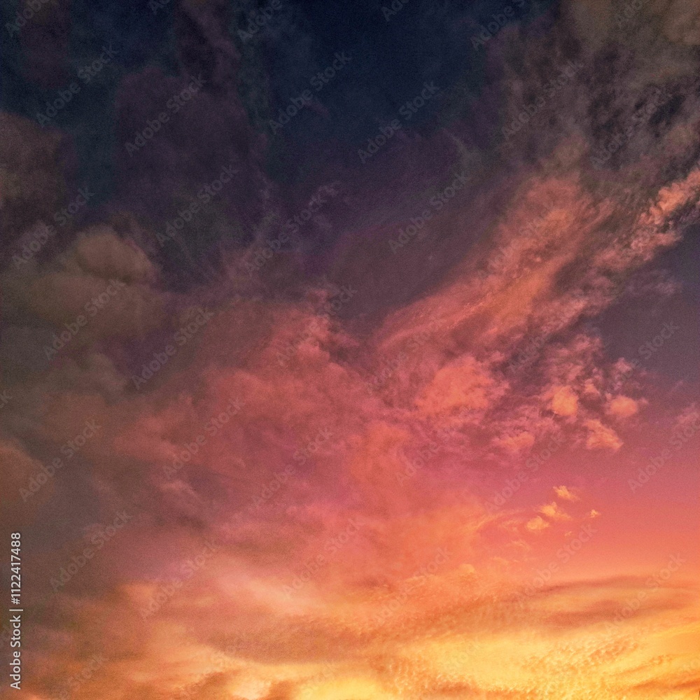 Obraz premium Summer clouds in vibrant sunset hues of yellow, orange, pink, and purple, creating a serene and colorful sky