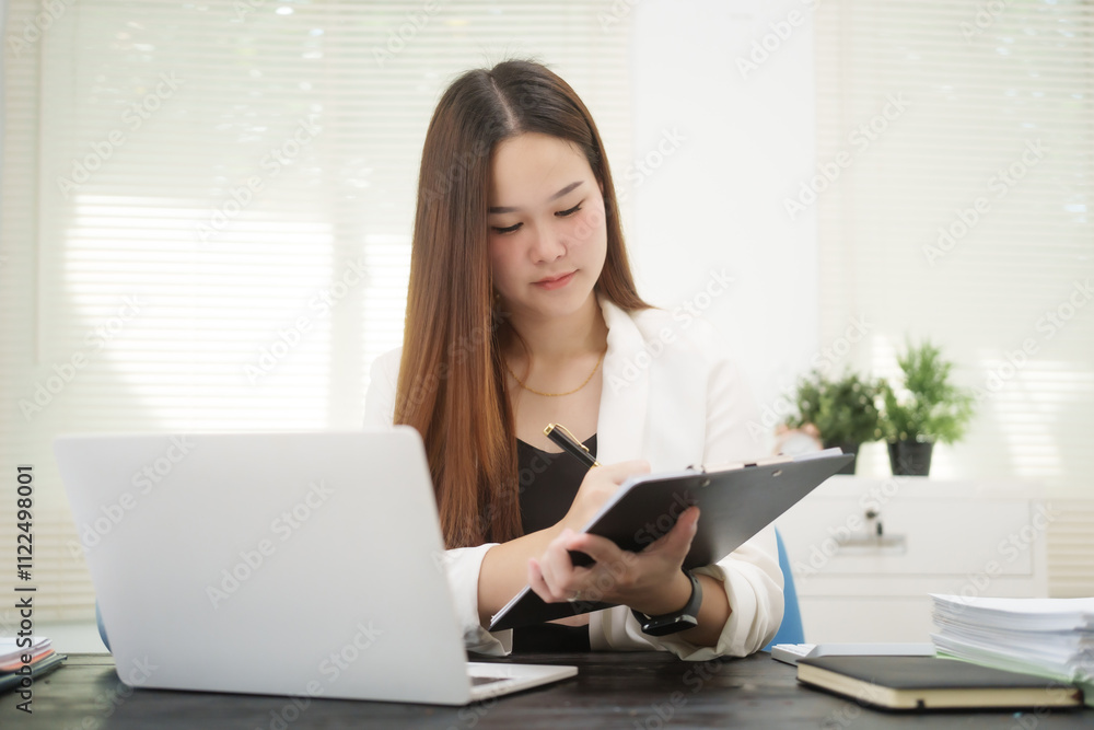 A young, professional businesswoman working at her desk in an office, providing online legal consultancy for disputed civil cases, addressing lawsuits, loan defaults, unfair dismissals, and property A young, professional businesswoman working at her desk in an office, providing online legal consultancy for disputed civil cases, addressing lawsuits, loan defaults, unfair dismissals, and property