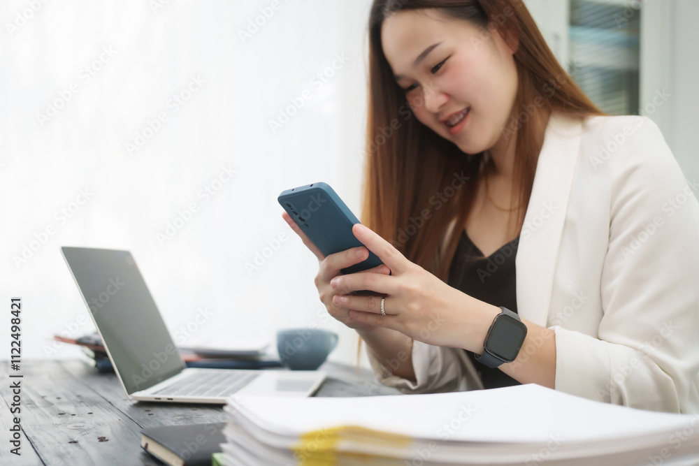 Fototapeta premium A young, professional businesswoman working at her desk in an office, providing online legal consultancy for disputed civil cases, addressing lawsuits, loan defaults, unfair dismissals, and property