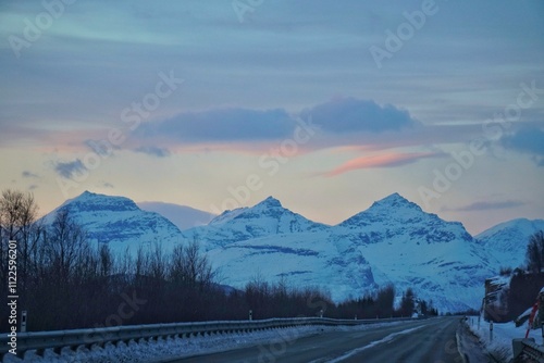 Obraz na płótnie A road with snow mountain background. w salonie