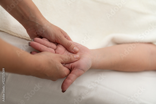 Professional masseuse doing arm and hand massage to a client