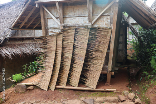 A traditional roof made from woven sago leaves provides shelter and charm. Its intricate design reflects the craftsmanship of the artisans, harmonizing with nature and showcasing cultural heritage in 