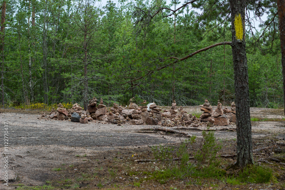 Obraz premium Pyramids of small stones on a slope. Monrepos Park. Vyborg.