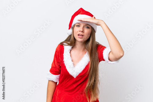 Young caucasian woman dressed as mama noel isolated on white background looking far away with hand to look something photo