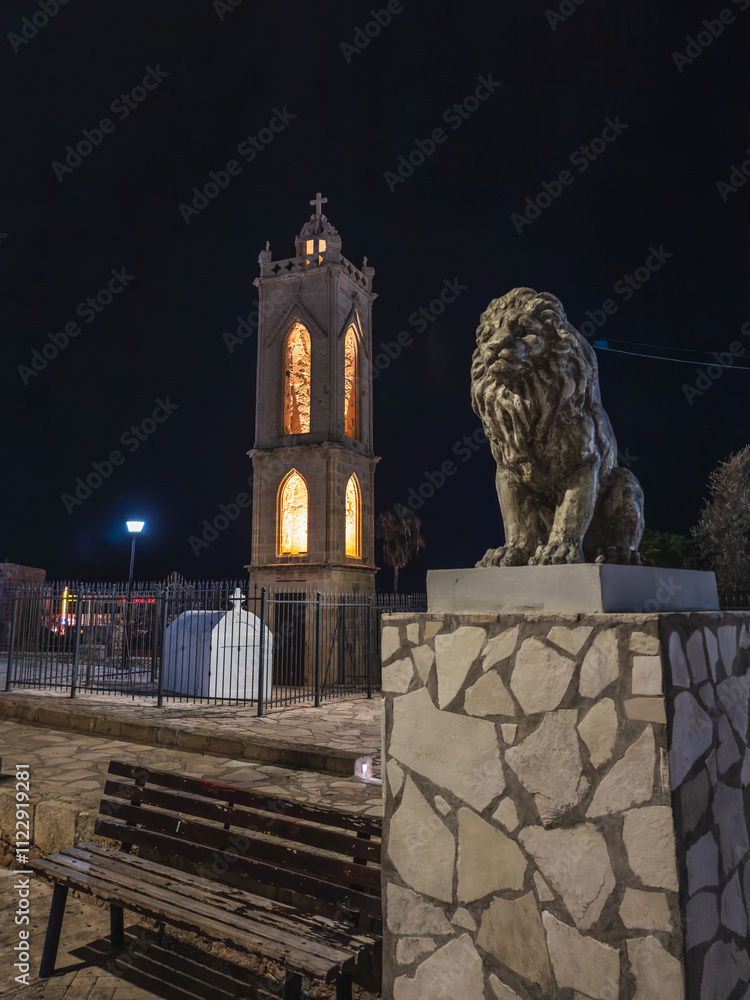 Illuminated Tower and Lion Statue at Night