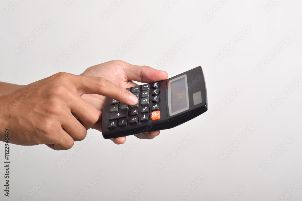 Hands holding and using a calculator isolated on a white background Hands holding and using a calculator isolated on a white background
