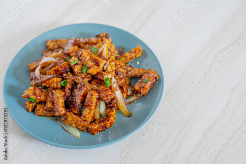 Side view of food background with traditional Indonesian food called tempe orek on marble background