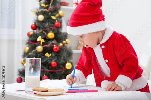 Obraz na płótnie little boy in Santa hat writing letter to Santat under the Christmas tree w salonie