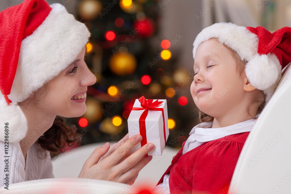 Mother surprising her daughter with christmas gift