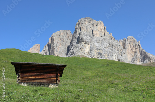 hut and the mountains of the European Alps of northern Italy in the background in summer without people photo