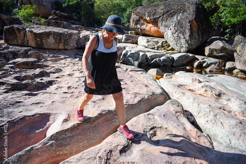 Woman walking on a rock photo