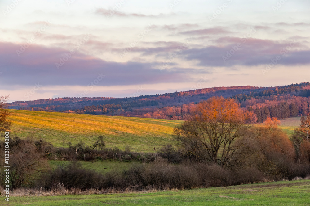 The evening sky over fields and forests. The last day of autumn.