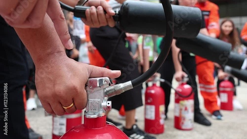 Employees firefighting training, Concept Employees hand using fire extinguisher fighting fire closeup	
