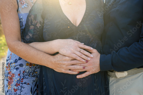 Photos three hands on pregnant surrogates baby bump for expecting parents maternity