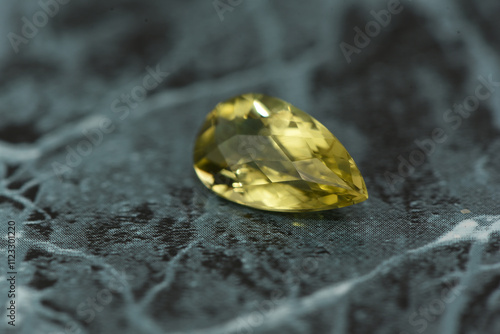 golden yellow citrine gemstone, on a black-white backgrond black-white marble