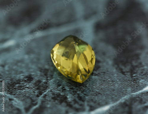 golden yellow citrine gemstone, on a black-white backgrond black-white marble