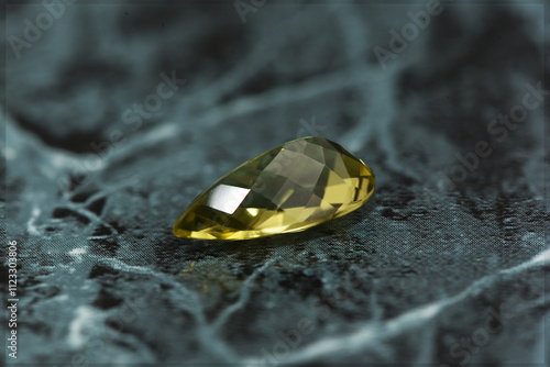 golden yellow citrine gemstone, on a black-white backgrond black-white marble