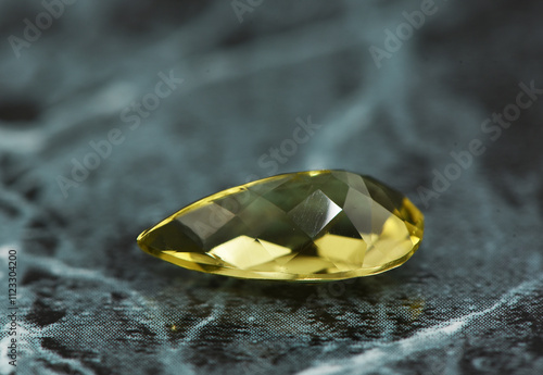 golden yellow citrine gemstone, on a black-white backgrond black-white marble