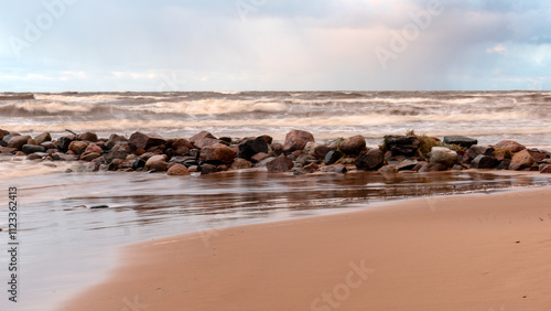 Obraz na plátně dramatic storm in the Baltic Sea, large waves crashing against the stone pier, b