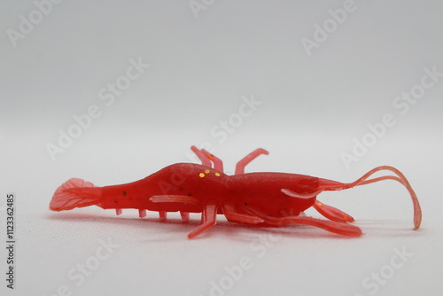 Red soft bait lure in shape of crayfish isolated on a white background. Fishing lures on white background. Fishing fake bait are another alternative to angling photo